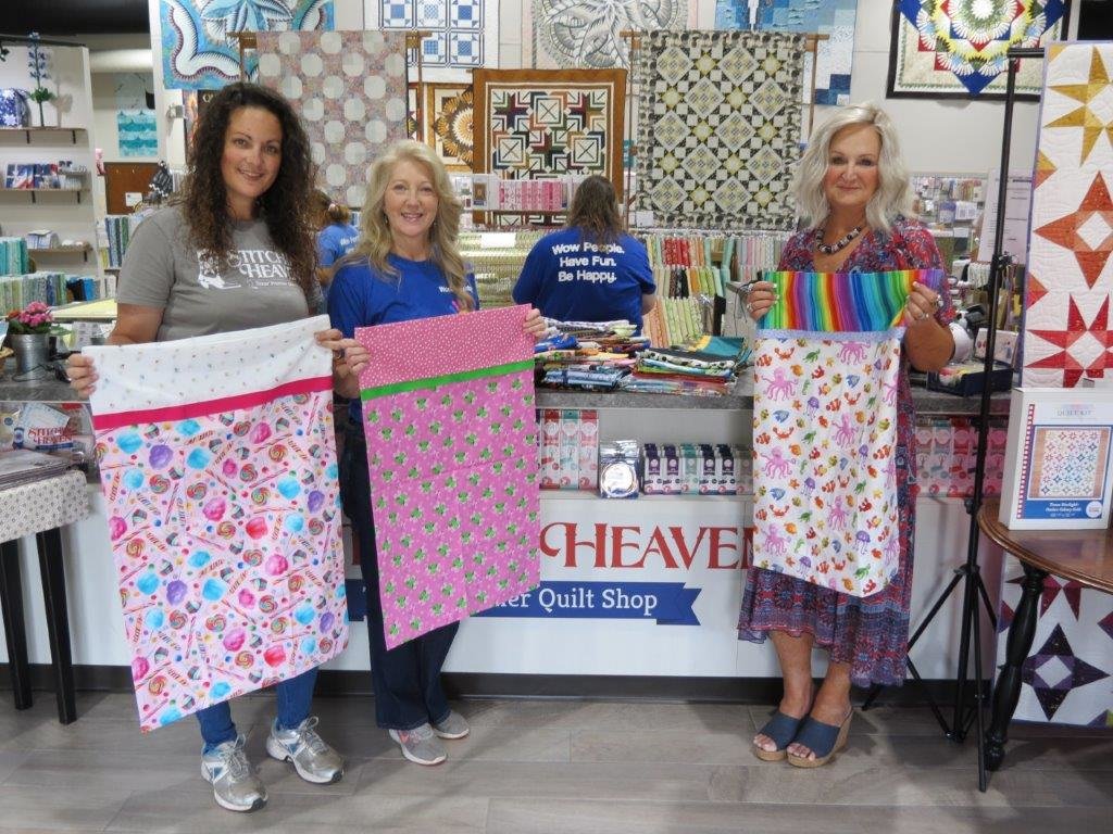 Pictured (from left) are Anita Williams, Stitchin’ Heaven marketing coordinator; JoAnn McMillan, Wood County Child Welfare Board president; and Deb Luttrell, owner of Stitchin’ Heaven.